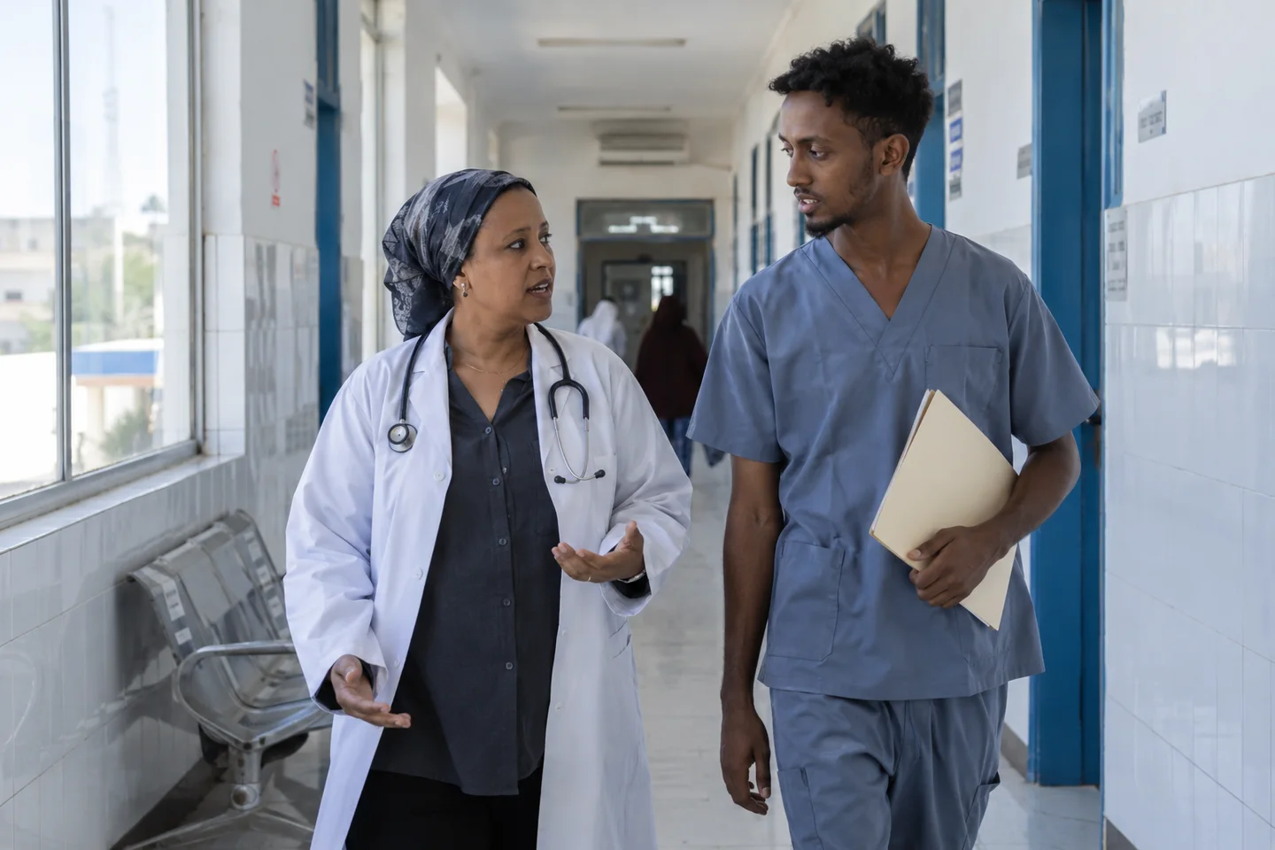 A doctor and a nurse talk in their clinic corridor in Djibouti