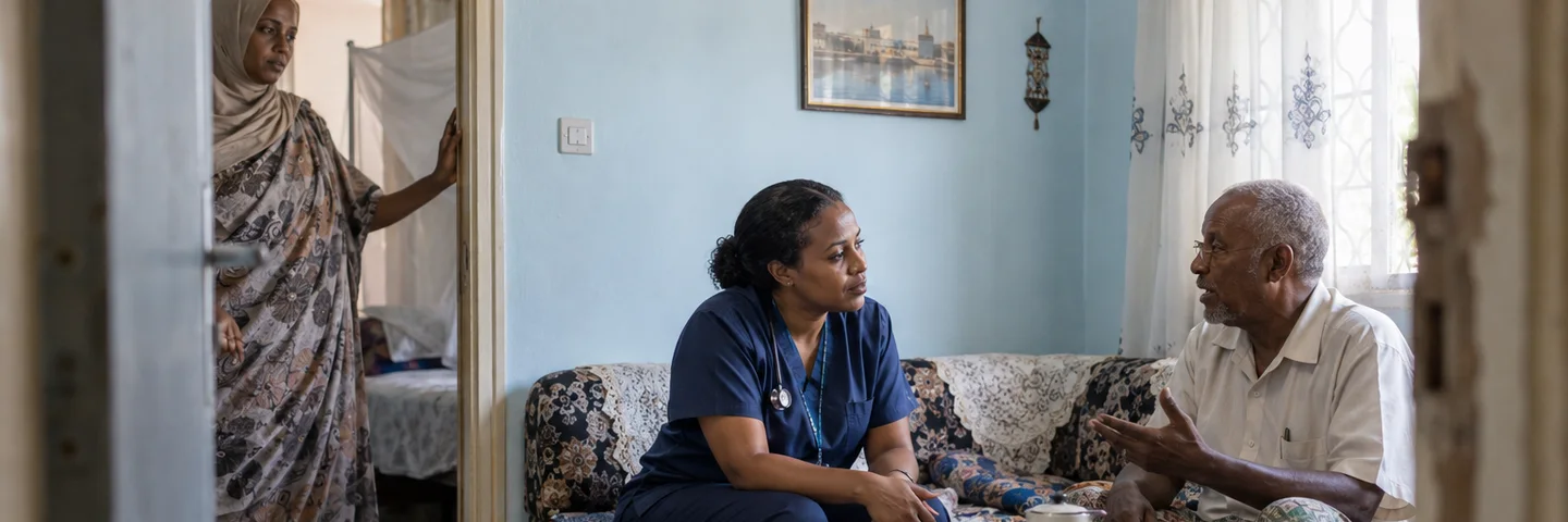 A nurse listens to an older man at his home in Djibouti, with his daughter nearby